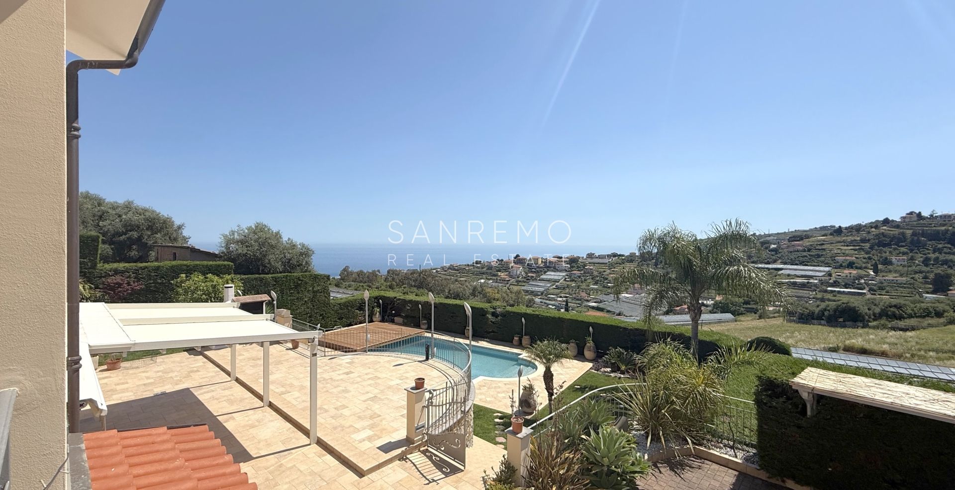 Beautiful villa surrounded by greenery with swimming pool and sea view
