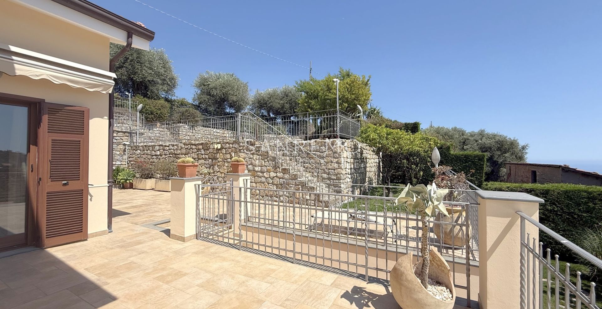 Beautiful villa surrounded by greenery with swimming pool and sea view