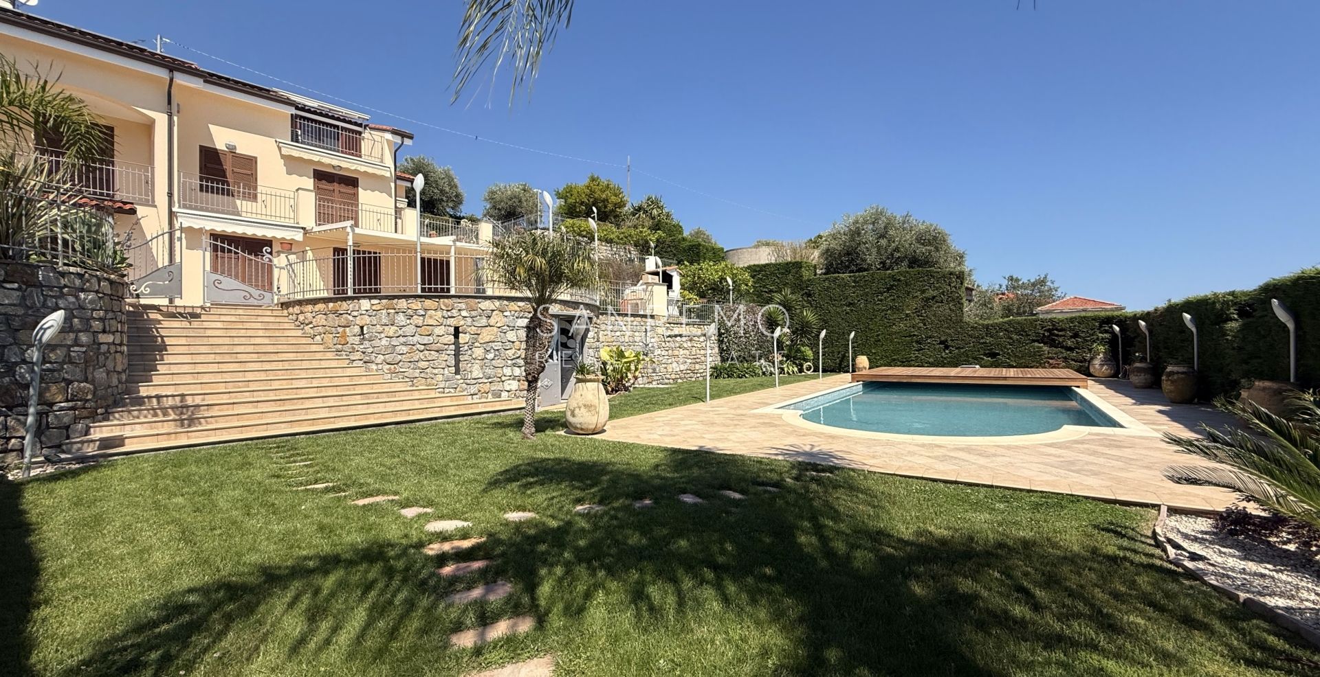 Beautiful villa surrounded by greenery with swimming pool and sea view