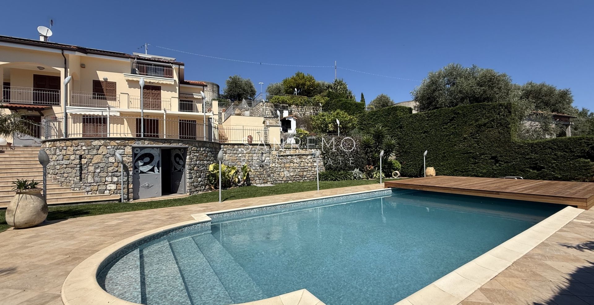 Beautiful villa surrounded by greenery with swimming pool and sea view