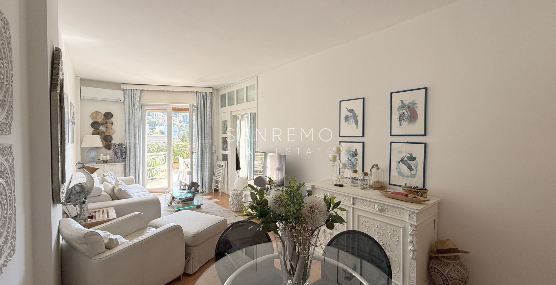One-bedroom apartment with a large terrace surrounded by greenery