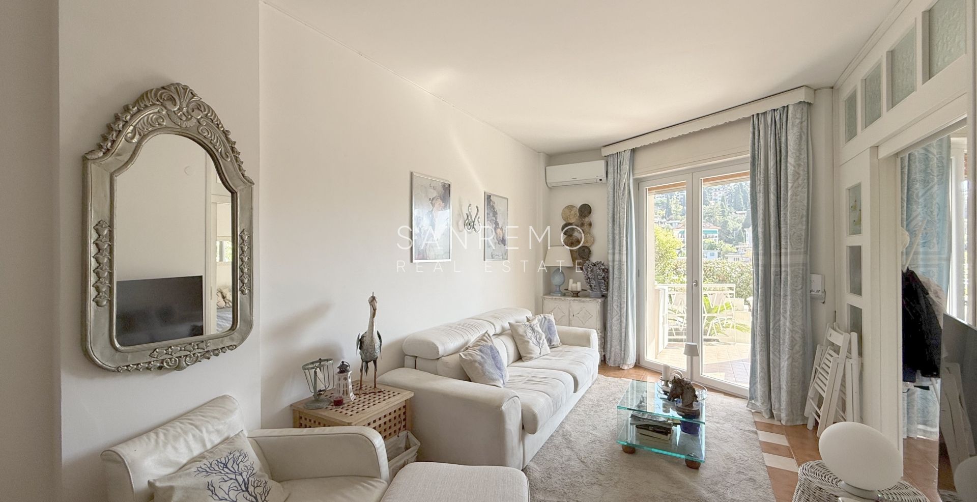 One-bedroom apartment with a large terrace surrounded by greenery